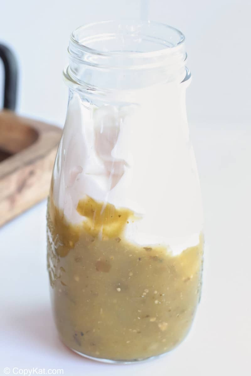 salsa verde and sour cream in a jar