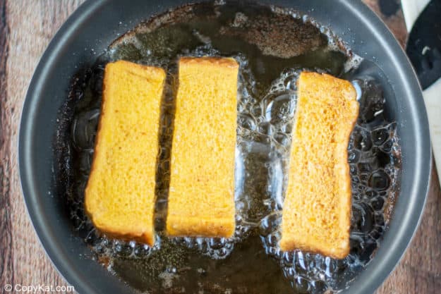 frying French toast sticks in a skillet