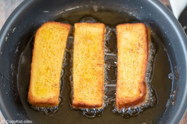 fried French toast sticks in a skillet