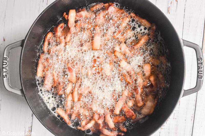 frying bacon pieces for huevos rancheros