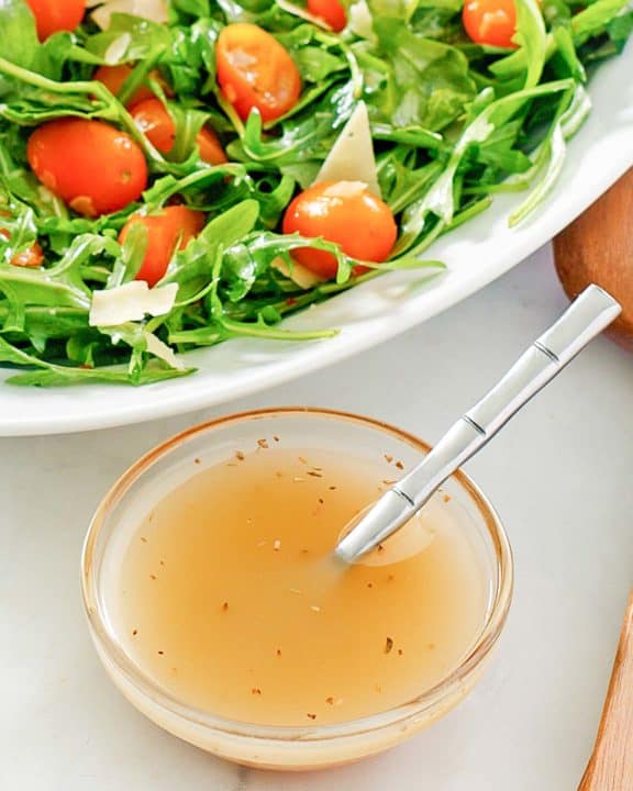 small bowl of homemade Italian dressing and a salad