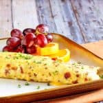 Homemade IHOP bacon temptation omelette and fruit on a plate