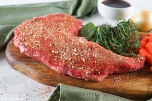 seasoned tri tip roast on a cutting board