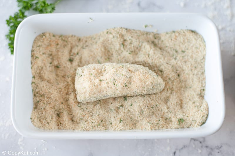 coating a cheese stuffed jalapeno pepper in breadcrumbs
