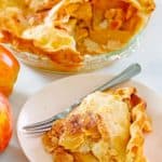 old fashioned apple pie and a slice on a plate
