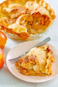 old fashioned apple pie and a slice on a plate