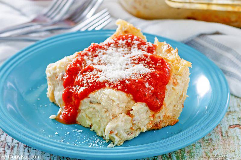 homemade Olive Garden 5 Cheese Lasagna topped with marinara and parmesan