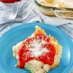 a serving of 5 cheese lasagna topped with marinara and parmesan