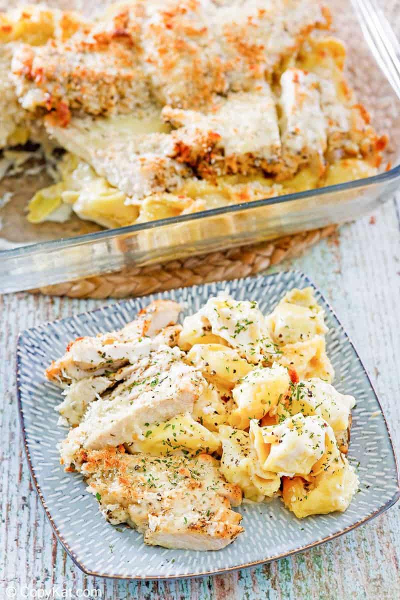 homemade Olive Garden Asiago Tortelloni Alfredo with Grilled chicken on a plate and in a baking dish
