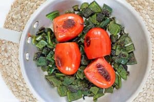 roasted peppers and tomatoes in a skillet