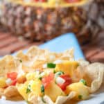 pineapple mango salsa and tortilla chips on a plate