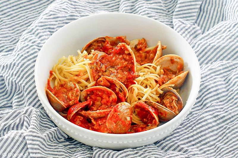 a bowl of clams, red clam sauce, and pasta
