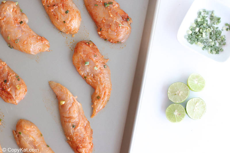 fajita seasoned chicken tenderloins on a sheet pan