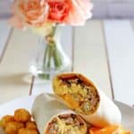 homemade Sonic ultimate meat and cheese breakfast burrito and tater tots on a plate