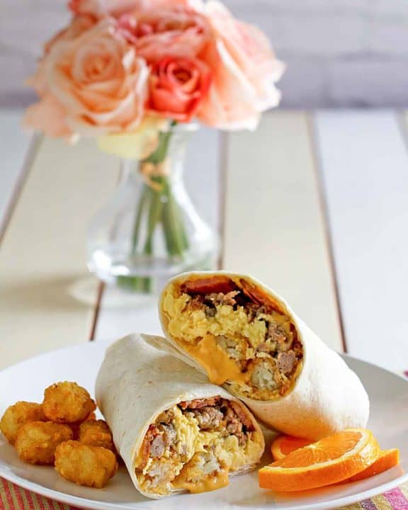 homemade Sonic ultimate meat and cheese breakfast burrito and tater tots on a plate