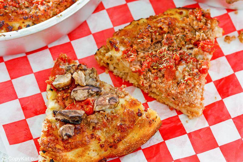 two slices of homemade Uno deep dish pizza with sausage