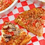 two slices of deep dish pizza with sausage