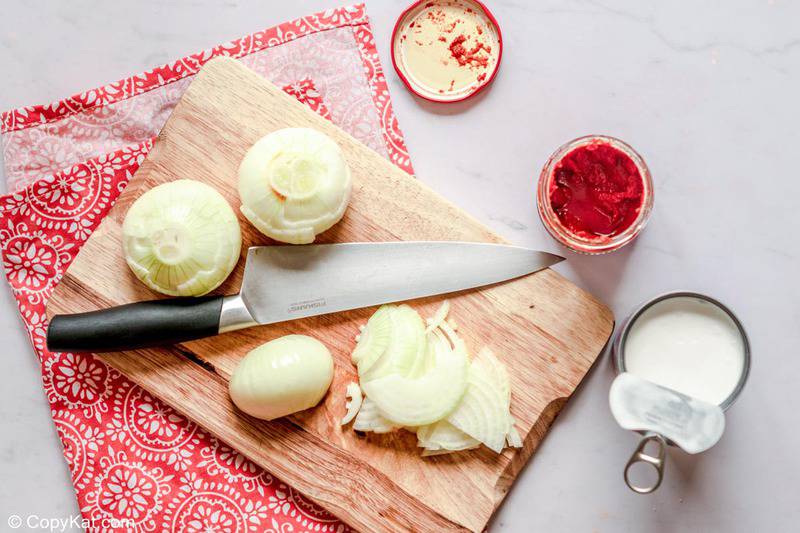 chopping onions for butter chicken sauce