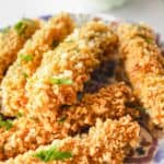 homemade Disney fried pickles on a plate and ranch sauce in a bowl