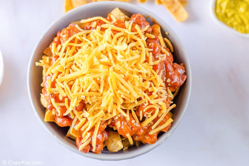 a bowl of Fritos topped with chili and cheese