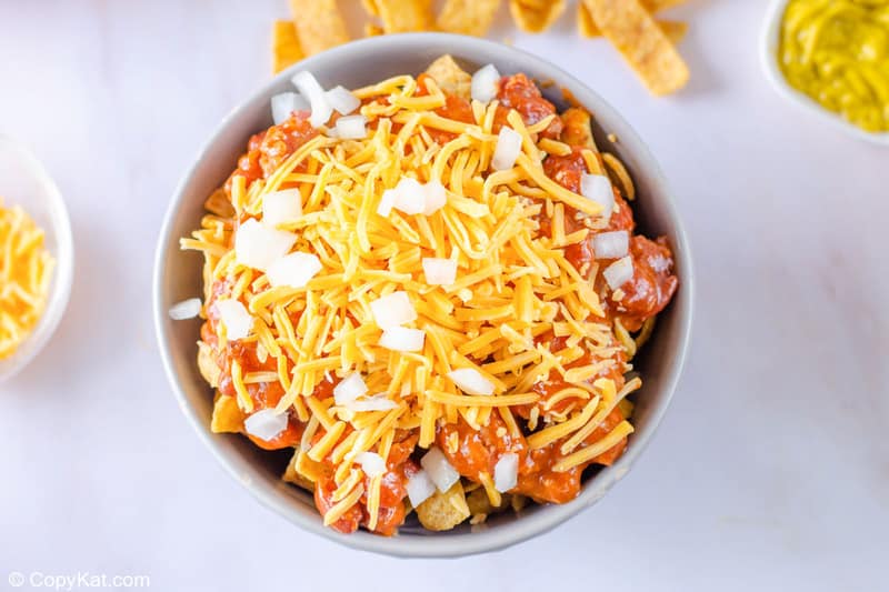Frito pie with onions sprinkled on top