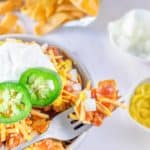 Frito Pie in a bowl and on a fork