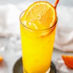 fuzzy navel cocktail drink with an orange slice garnish