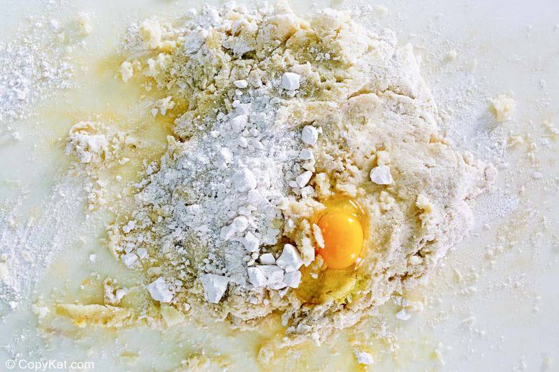 mashed potatoes, salt, flour, and egg on a work surface
