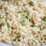 white cheddar macaroni and cheese in a white serving dish