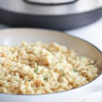 a bowl of white cheddar mac and cheese in front of an Instant Pot