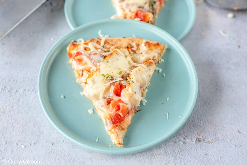 a slice of homemade Olive Garden Chicken Formaggio Pizza
