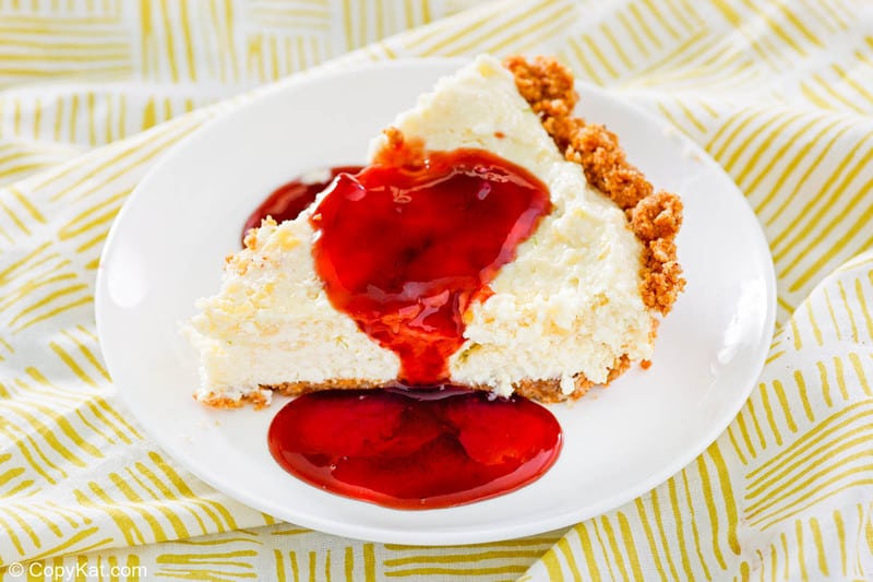 a slice of homemade Pappadeaux key lime pie topped with raspberry sauce