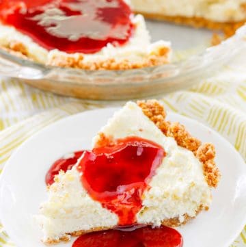 homemade Pappadeaux key lime pie with raspberry sauce in a pie pan and a slice on a plate