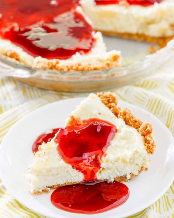 homemade Pappadeaux key lime pie with raspberry sauce in a pie pan and a slice on a plate
