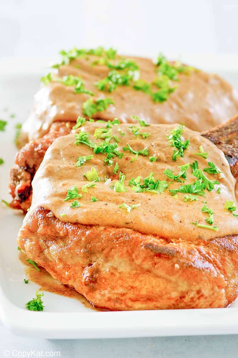 two fried pork chops with gravy