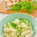 a bowl of homemade potato gnocchi topped with parmesan and parsley