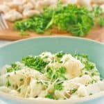 potato gnocchi in a bowl topped with parmesan and parsley
