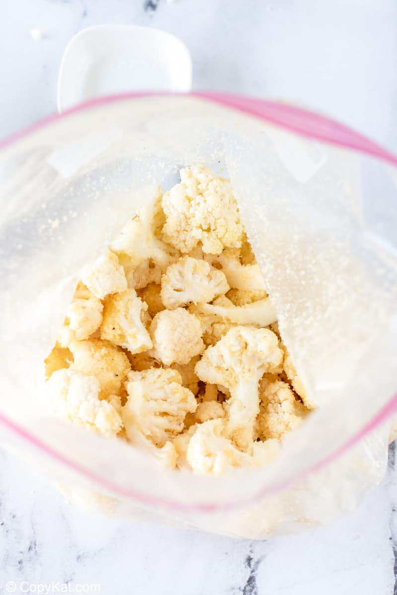 seasoned and coated cauliflower in a bag