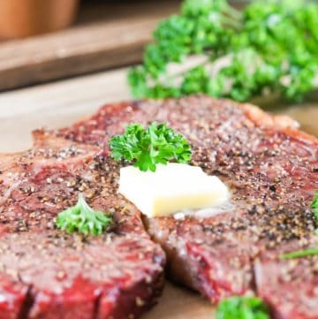 smoked steak topped with butter and parsley