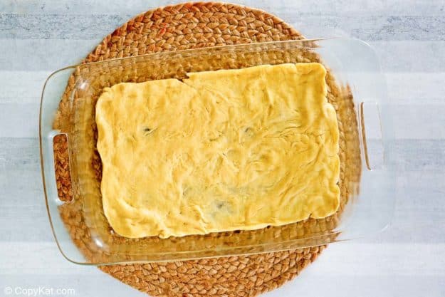 crescent roll dough in the bottom of a baking dish