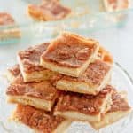 sopapilla cheesecake slices stacked on a cake stand