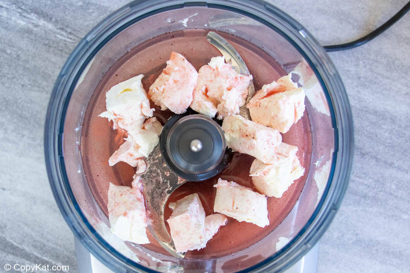 cubed cream cheese and strawberry juice in a food processor