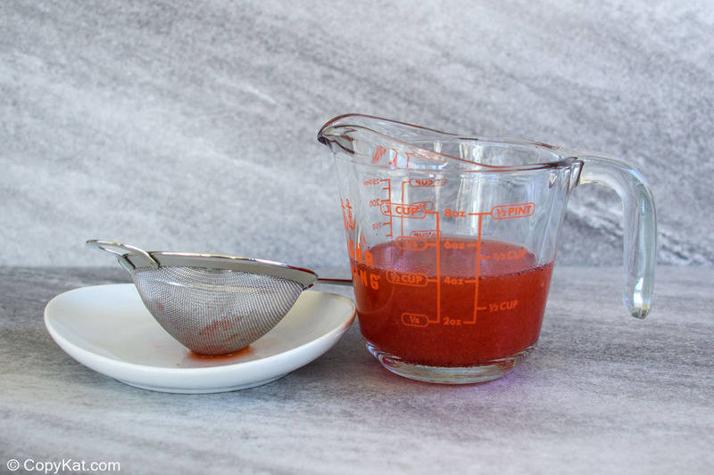 juice from frozen strawberries in syrup in a measuring cup