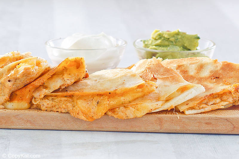 homemade Taco Bell chicken quesadilla slices, guacamole, and sour cream