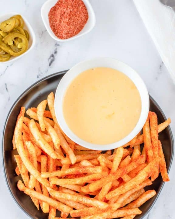 overhead view of homemade Taco Bell nacho fries and cheese sauce