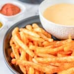 homemade Taco Bell Nacho Fries and cheese sauce on a plate