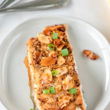 air fried salmon almondine on a white plate