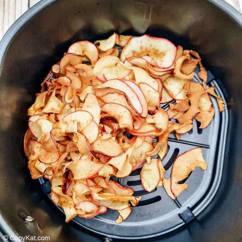air fried apple chips in an air fryer basket