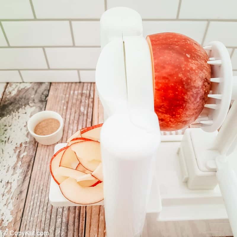 apple on a spiralizer and spiralized slices
