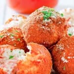 Arancini Italian Rice Balls on a plate and marinara sauce in a small bowl